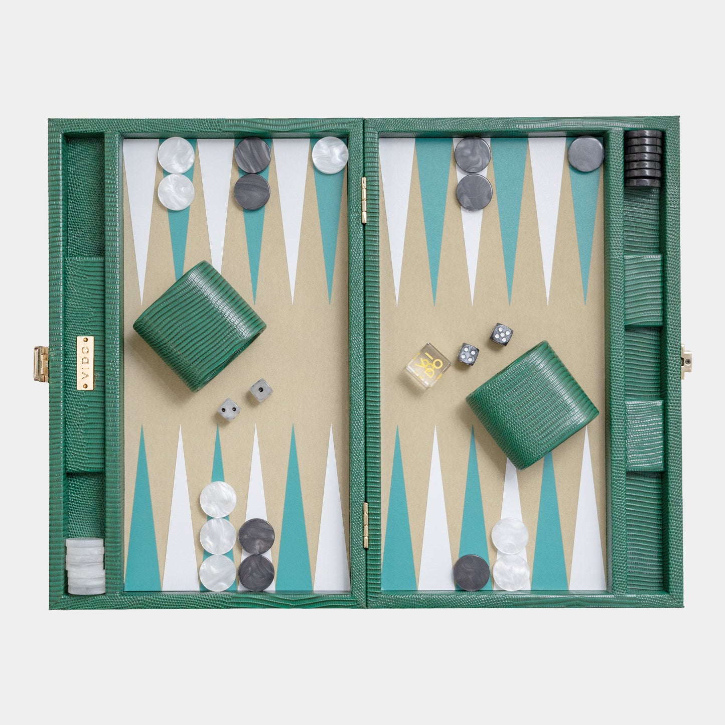 Backgammon set with green board and pieces on a white background by VIDO